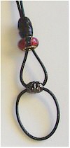 Red and black barefoot sandal, carved wood, charm bead, on leather cord. 