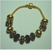 Gold and black charm bracelet.