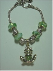 Tibetan Silver Frog charm and green crystal bracelet.