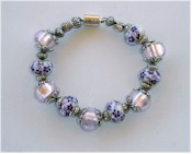 Pink and purple flowers bracelet with magnetic closure.