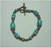 Turquoise and antique bronze bracelet with toggle clasp.