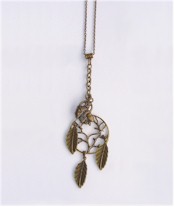 Antique brass Indians and leaves hang from an antique brass Tree of Life on brass chains.