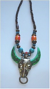 Festive water buffalo pendant on Turquoise, red Coral and Emerald green beaded necklace.