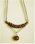 Amber bead drop with bronze pearls and antique bronze brass.