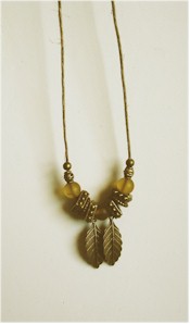 Antique brass and frosty golden beads on hemp cord, with falling Autumn brass leaves.