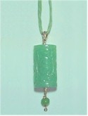 Carved Jade pendant on silk cord.