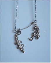 Pewter tiger and crocodile charms on pewter chain.