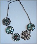 Faceted glass flowers, aqua foil disks set in metal on necklace chain.