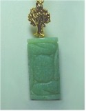 Gold Tree of Life suspended over carved Jade Pendant necklace.