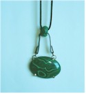 Green Malachite pendant on black flat-formed metal and suede cord.