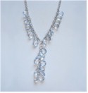 Pale faceted blue beads fall gracefully down chain.