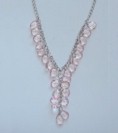 Faceted pale pink beads cascade down from necklace chain.