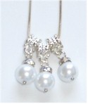 Three faux pearls dangle from silverplate bails on chain.