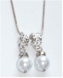 Two faux pearls on silverplate bails dangle from silver chain.