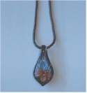 Floral lampwork glass pendant on copper wire knit necklace.