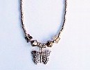 Filigree silver butterfly charm with Tibetan silver beads all along necklace chain.