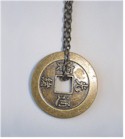 Antiqued brass coin on chain link necklace.