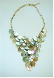 Rows of mother-of-pearl disks dangle from silver chain necklace.