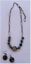 Necklace of Freshwater pearls and an abalone disk on varied link antique bronze chain. 