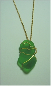 Gold wire wrapped emerald green seaglass on gold chain.