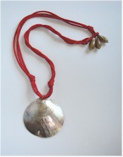 Pearly shell pendant on knotted red silk cords necklace.