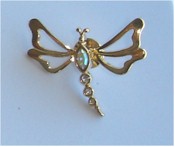 Vintage goldtone bejeweled dragonfly brooch.