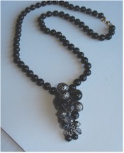 Black filigree and clear faceted bead cluster on Monet beads necklace.